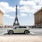 Auto elettrica davanti alla Torre Eiffel a Parigi